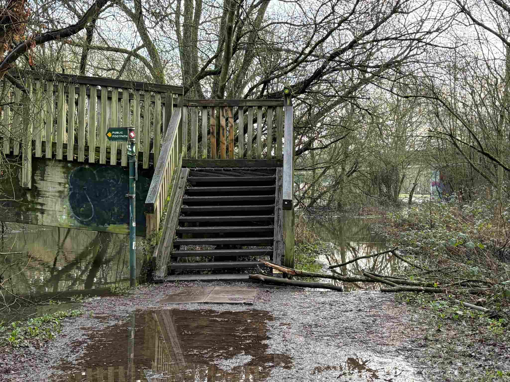 Approaching Colemansmoor Bridge from the A329M bridge, the path has some large puddles.